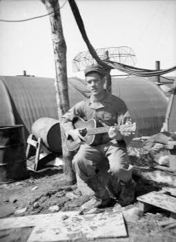 Bert Crowson holding a guitar