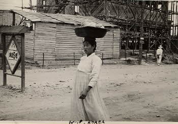 Korean woman setting a basket on her head