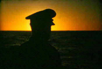A soldier looking at sunset in USS Mitchell