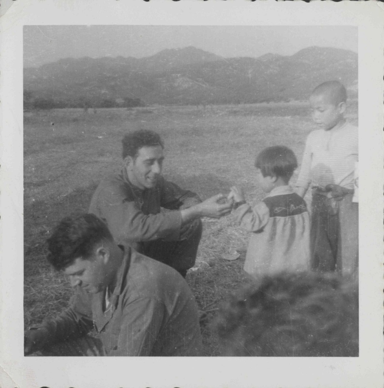 Steven Montalbano and his comrade feeding orphans 