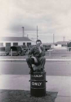 Edward Grala sitting on trash can	