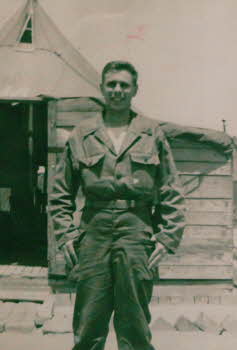 A soldier in front of military base