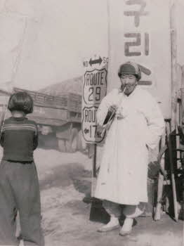 A Korean old man smoking and one young girl