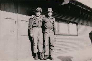 Two soldiers with their arms around each other's shoulders
