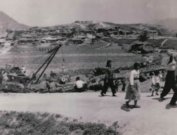 Korean people and tanks in a line