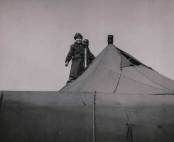 Dave Allen wearing winter coat on top of tent