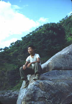 Korean guide sitting on rocks