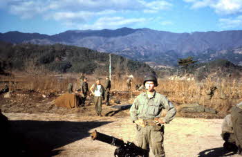 Peter Doyle standing in front of water cooled Machine Gun