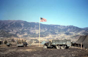 View of Co. D, 17th REGT, Reserve area to NE. 2 1/2 ton truck, tents, U.S. Flag, Thawing + mud