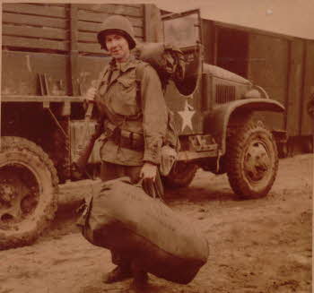 Peter Doyle in front of a military truck