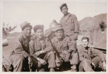 In reserve area at west end of Hwachon reservoir, ROK army soldiers attached to Co.D. 17th Infantry Regt. 7th division. Ha young sub (standing), Jin Jong man (second from right), Pete Doyle (at extreme right)
