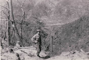 Peter Doyle's squad leader SGT. John Berns at Old Baldy. The view is to the west where 31st Regt. + Ethiopian battalion were. Shell holes can be seen from our artillery. Battles continued there after 'Old Baldy'. Enemy attacked two nights in a row over there.