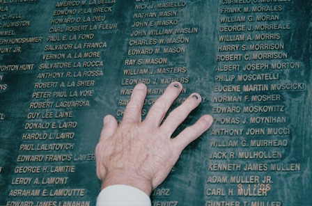 BRONZE PLAQUE OF U.S. KILLED IN ACTION, POINTING AT HIS FRIEND' NAME (Richard Houser's hand)