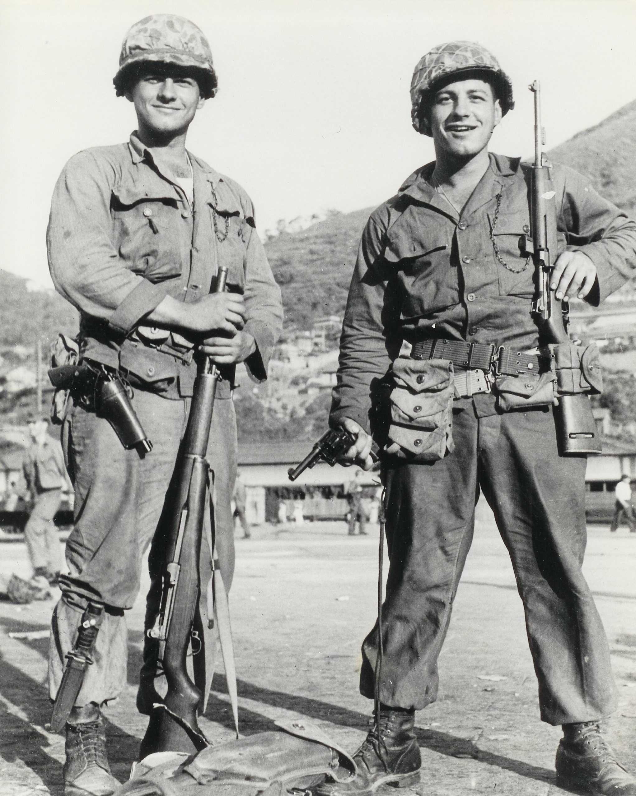 Richard and Robert Mercy at the side of a dock waiting to board ship headed to Busan. Taken on 4 July, 1950.