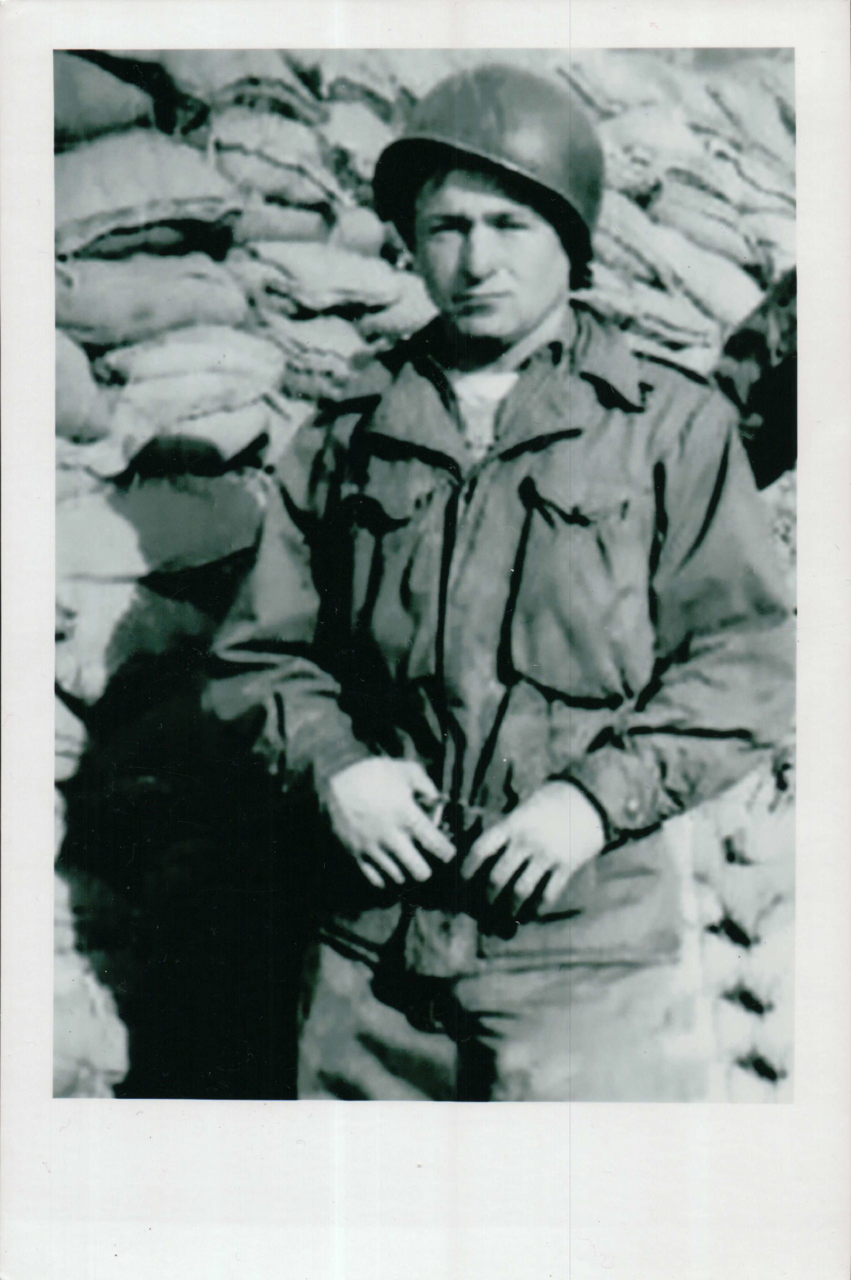 Rosser standing in front of a bunker in Kumhwa Valley in 1951.