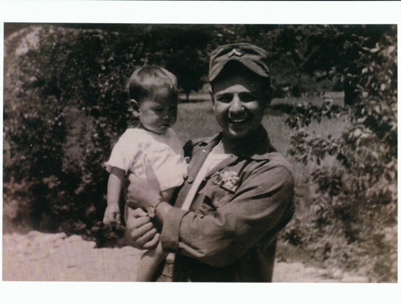 Nuzzo holding a Korean child in Sambatt Village, 1954.