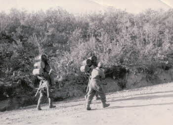 Korean service corps carrying barrels with a Korean A-frame on their back