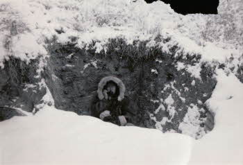 Bill O'Kane wearing fur coat in middle of snow