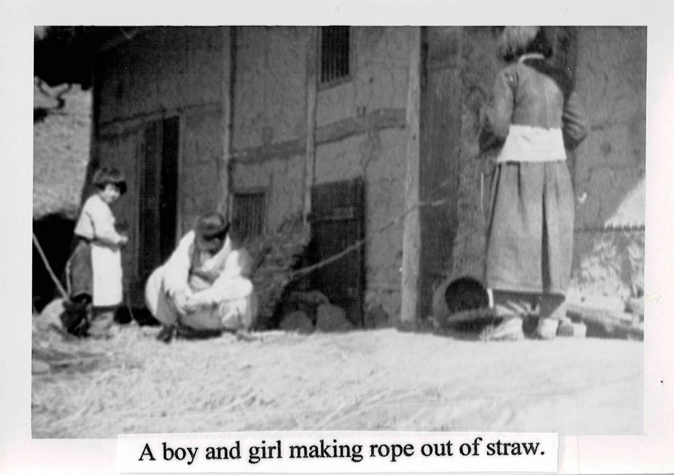 A Boy and Girl Making Rope out of Straw