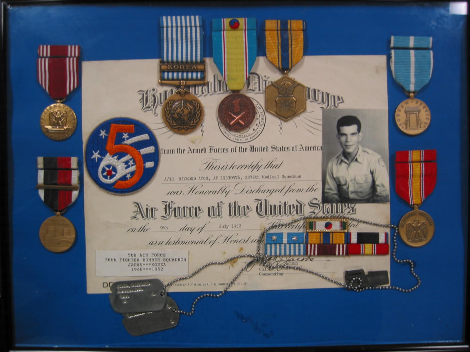 [Front]: Color digital print of Ayon's service medals and honorable discharge certificate, along with a photo of Ayon