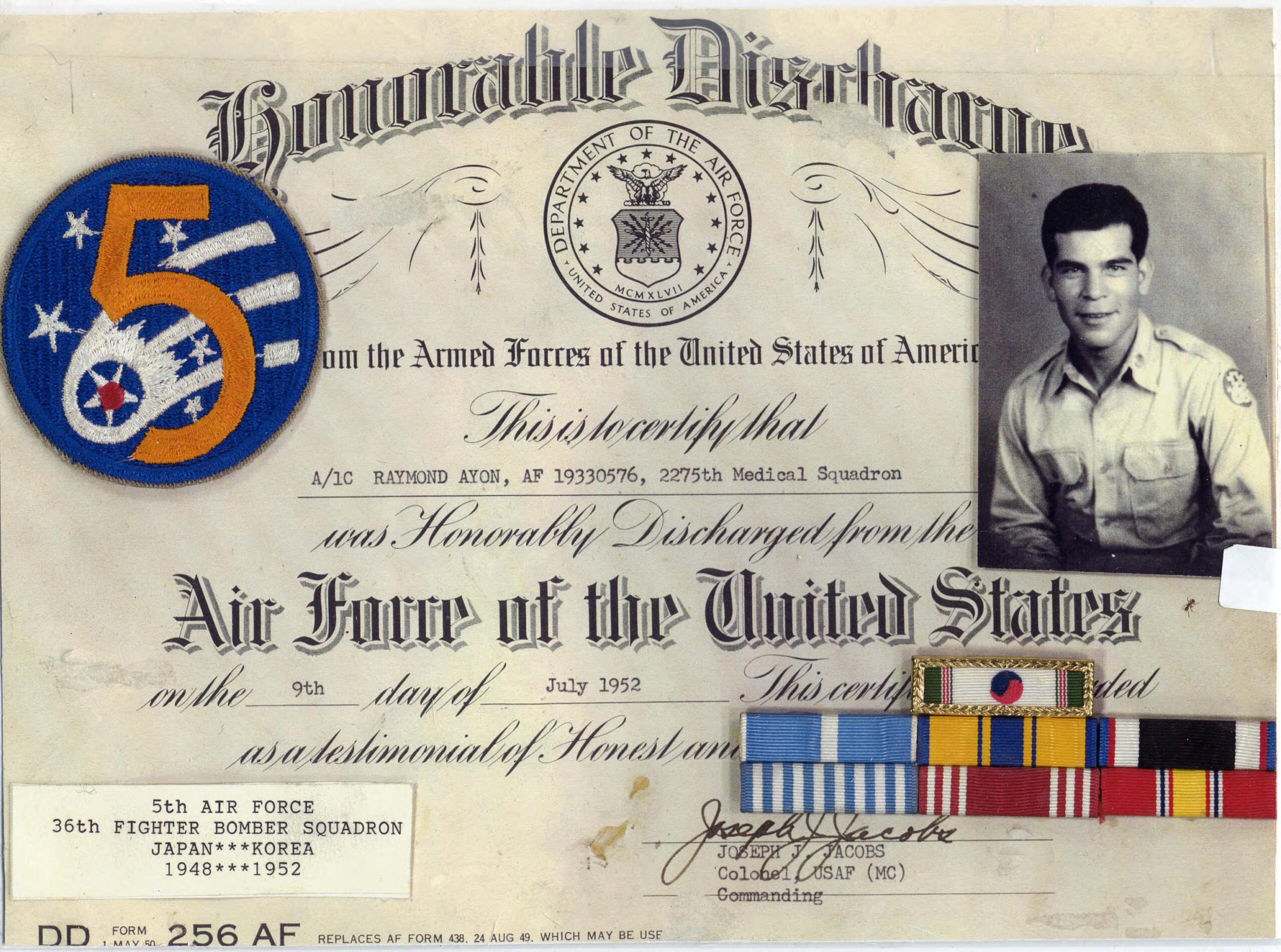 Honorable discharge certificate with a photo of the veteran, sleeve patches, and other decorations